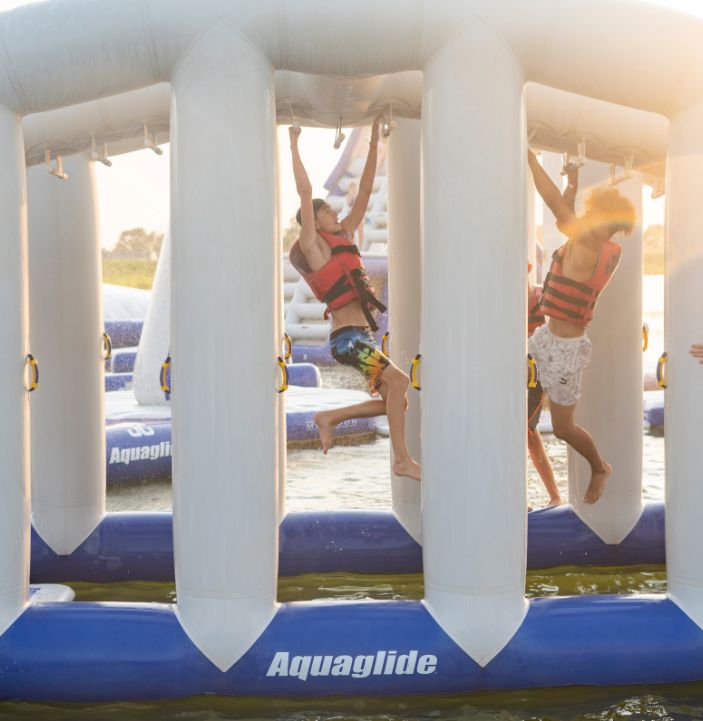 people hanging from monkey dome aquapark inflatable in rye near camber sands