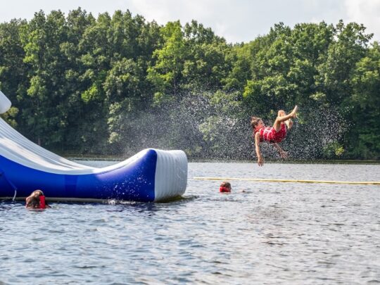 boy flying through the air launched from waterslide at rye aquapark in east sussex