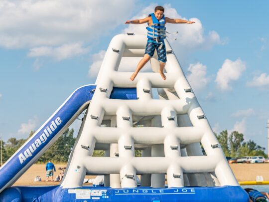 boy launching off the top of the jungle jim inflatable at rye watersports aquapark